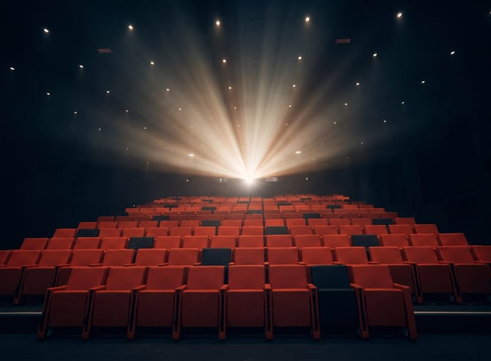 La salle de cinéma du campus EICAR, faisceau du projecteur au-dessus des fauteuils rouges